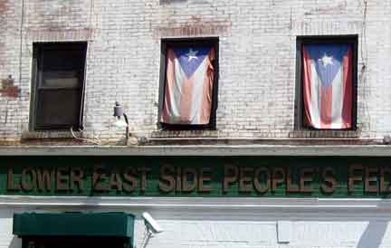 Puerto Rican flags on display in windows on the Lower East Side / courtesy Brandon Rigby.
